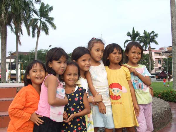 Kids playing in the garden of the Maimoon Palace at Medan