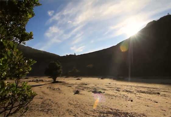 Sun peeking over the rim of Tangkuban Perahu crater, near Bandung